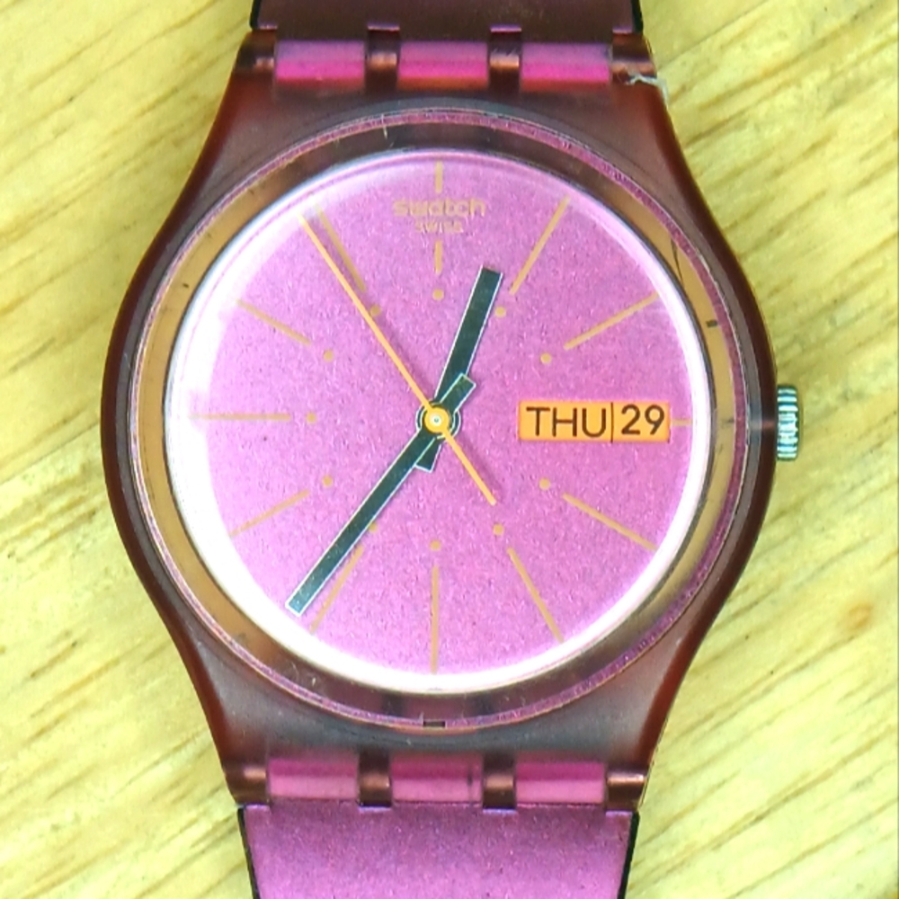 X Swatch Sneaky Peaky clear rose case metallic pink dial orange hr marks day